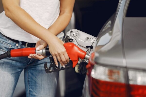 Elegant woman standing on a gas station