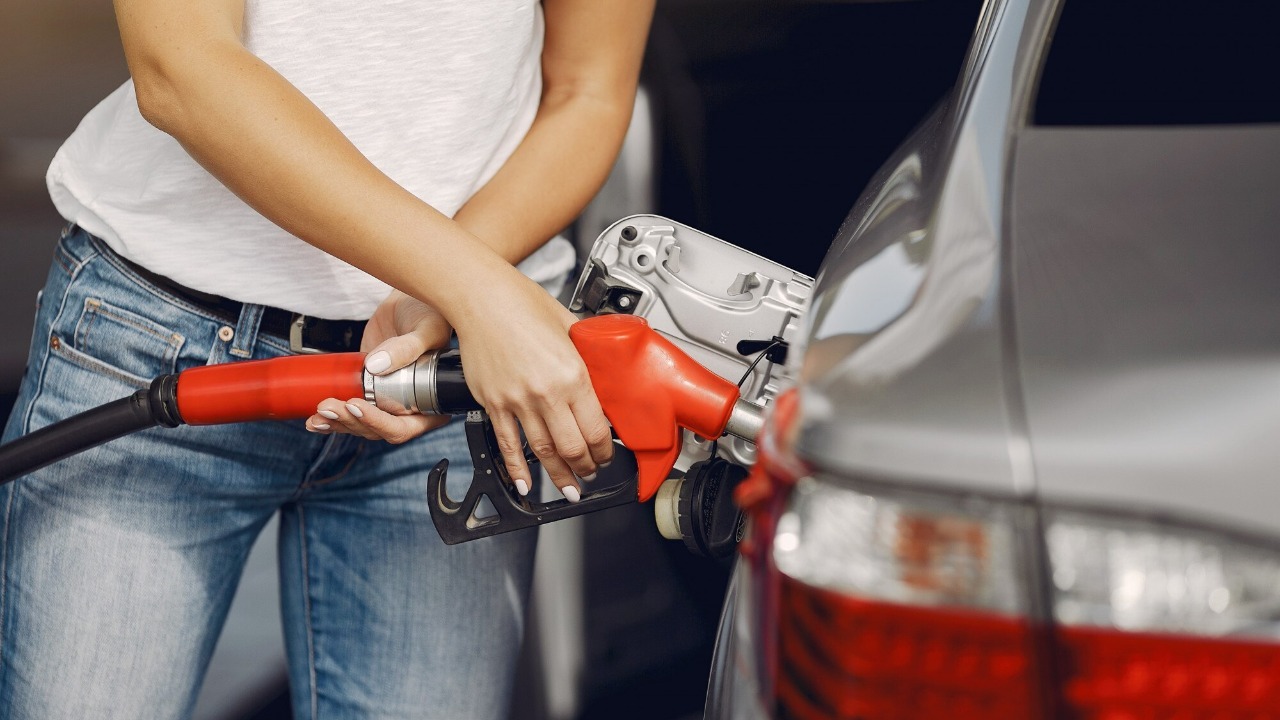 Elegant woman standing on a gas station