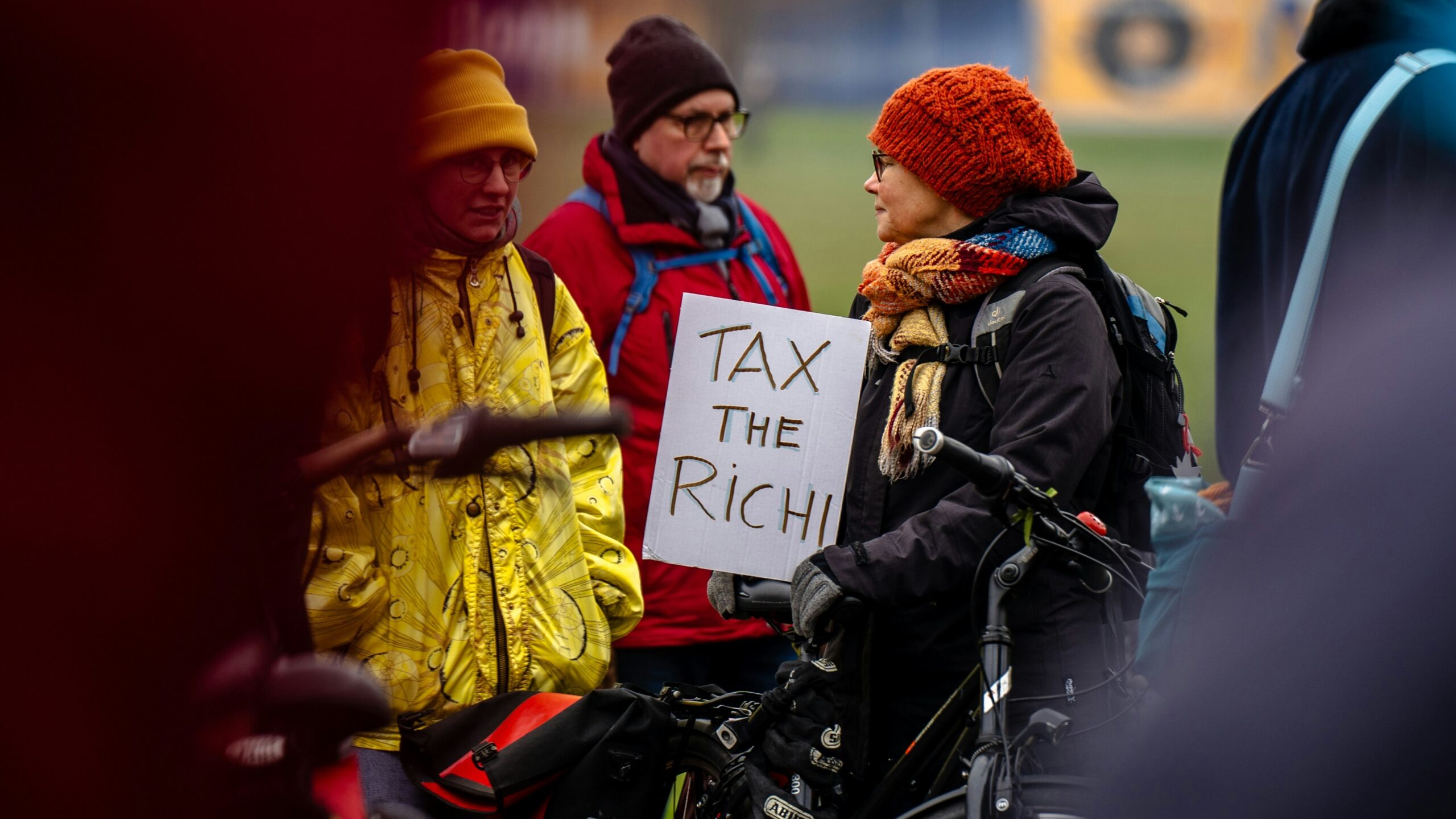 A person in a wheelchair holding a sign