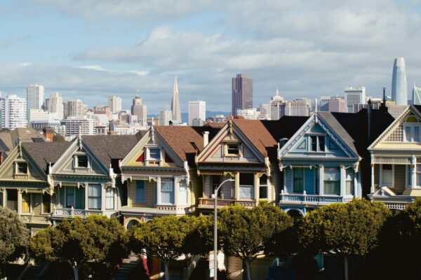 a row of houses with a city in the background