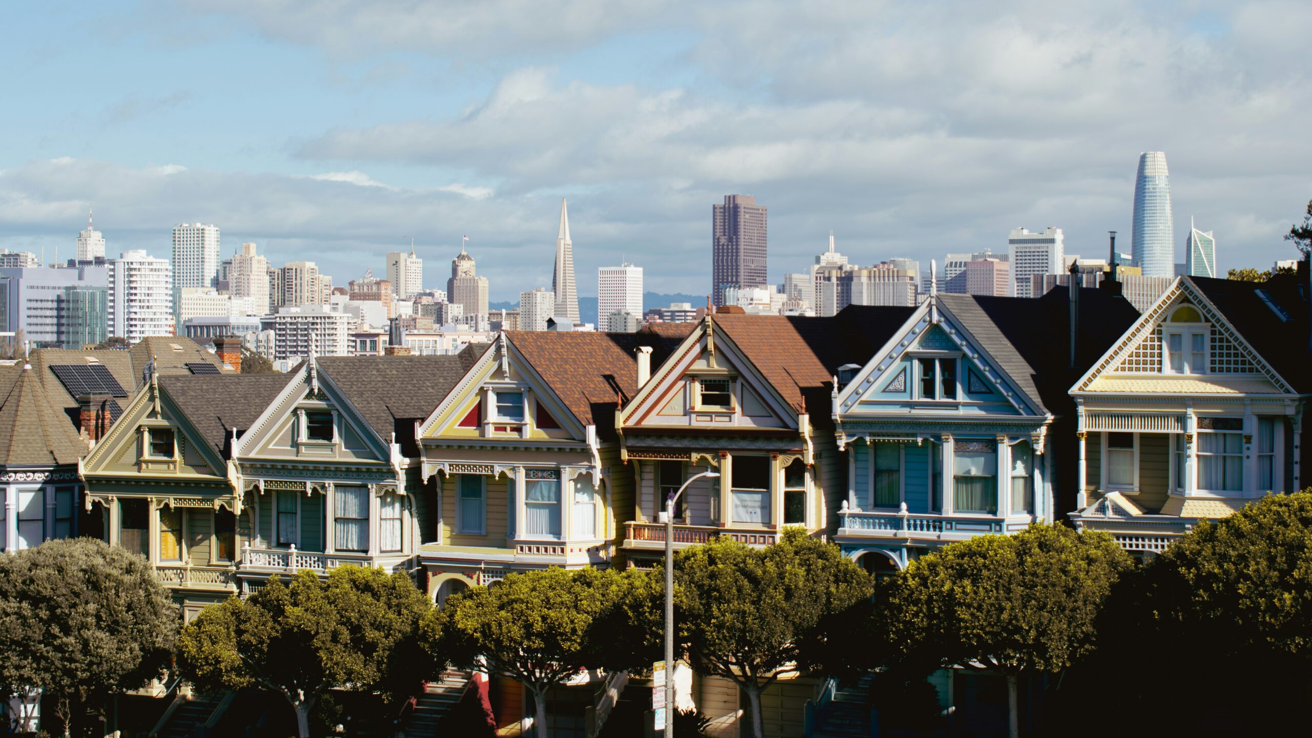 a row of houses with a city in the background