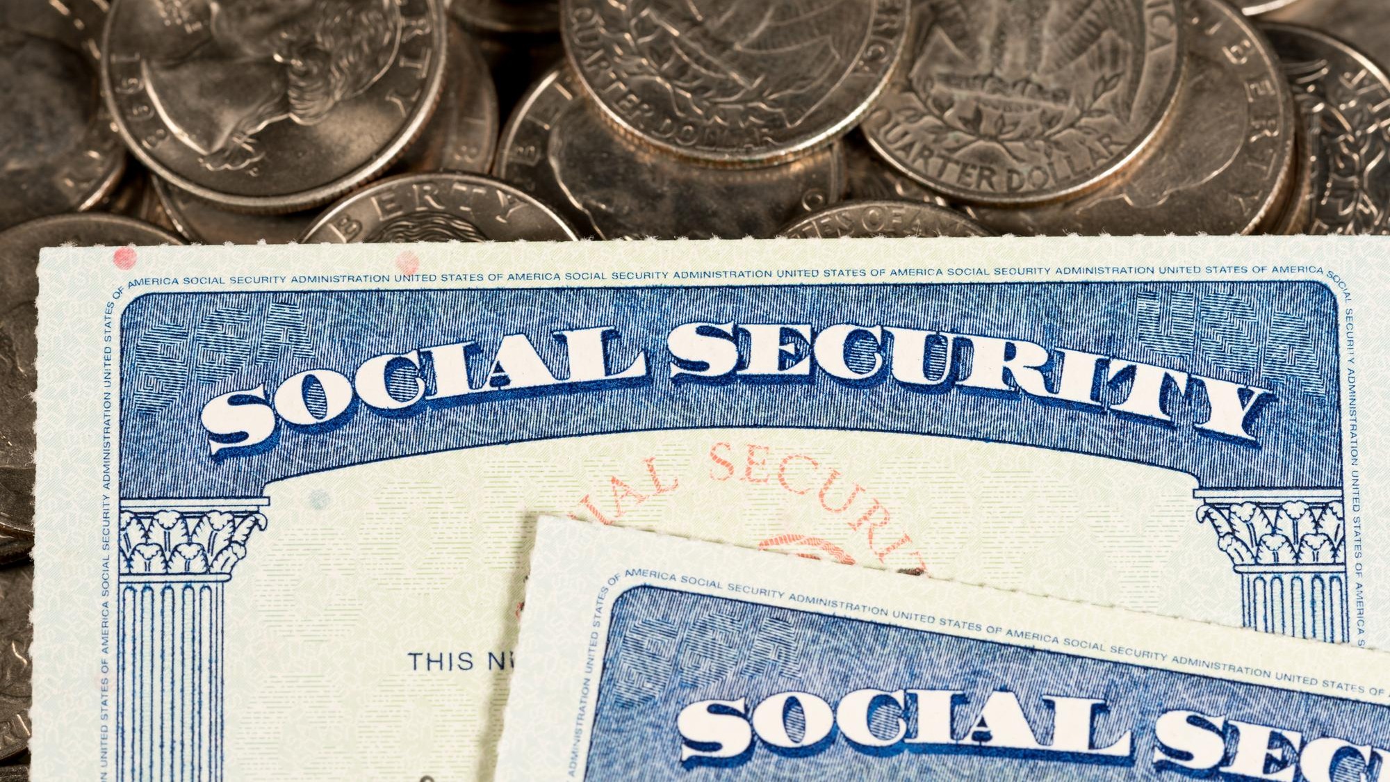 USA Social security cards laid on quarter coins