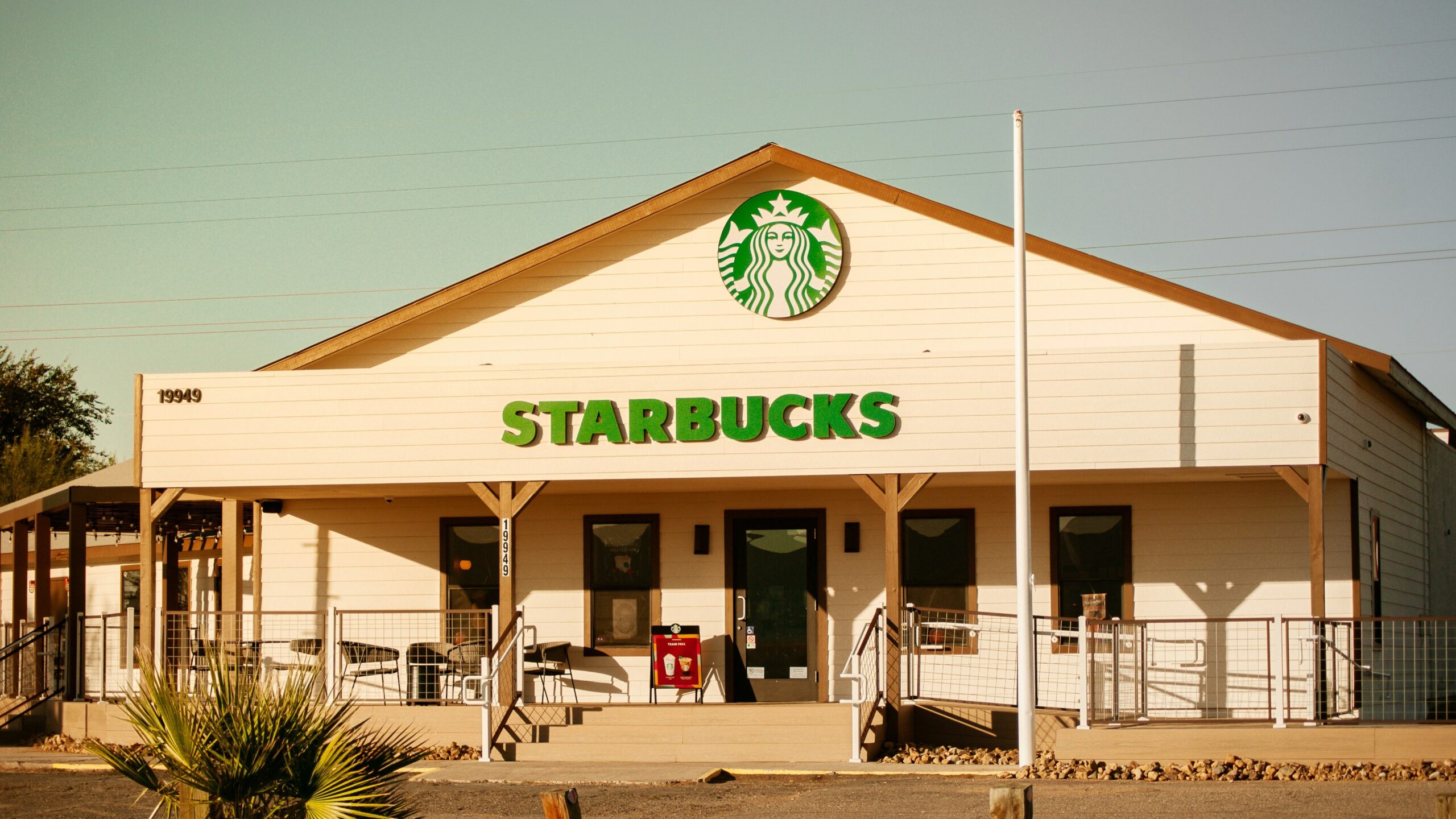 a starbucks coffee shop with a flag on top of it