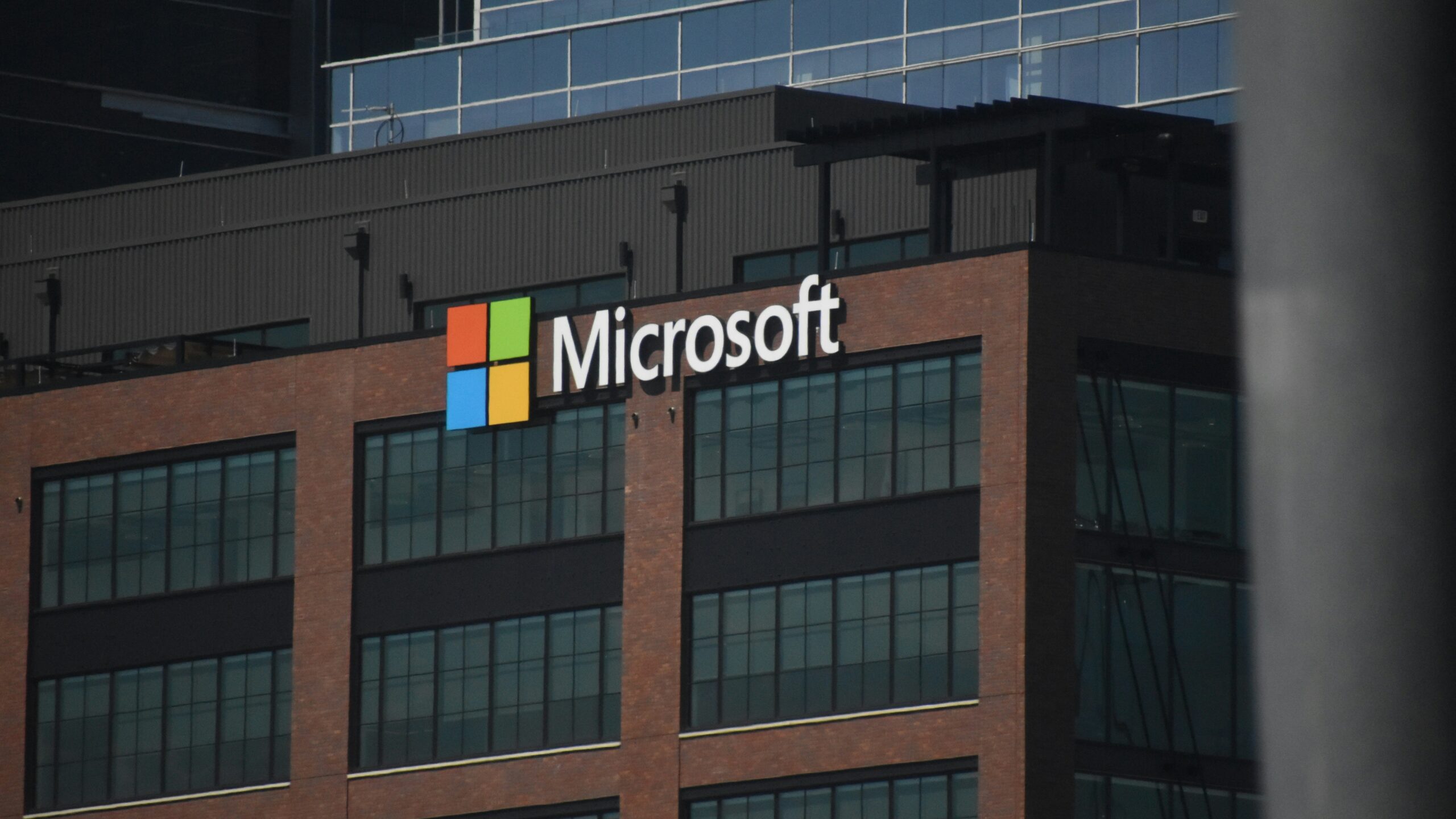 A tall building with a microsoft logo on top of it