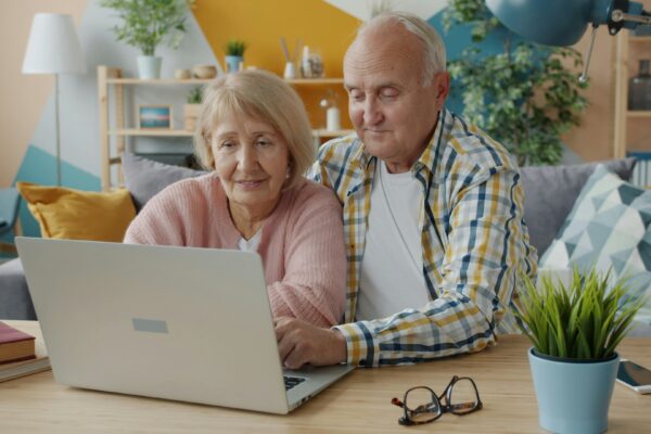 Elderly couple looking at a laptop together