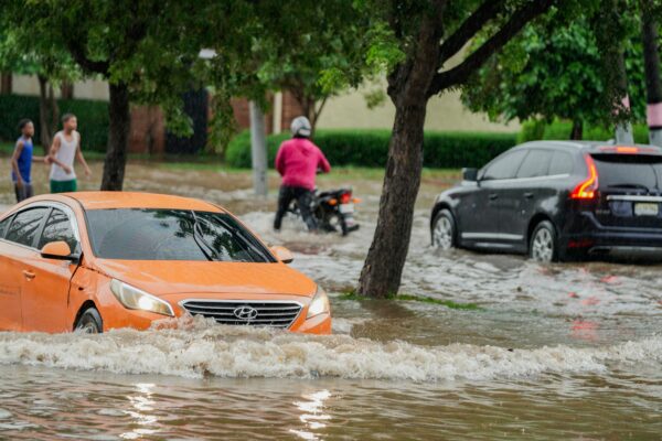 A group of people walking through a flooded street