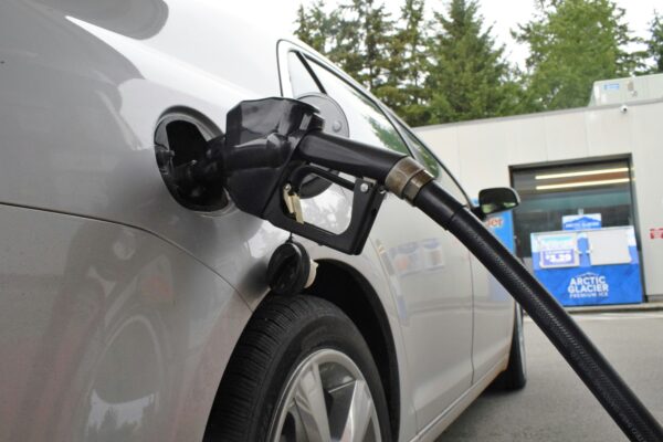 an electric car being charged at a gas station