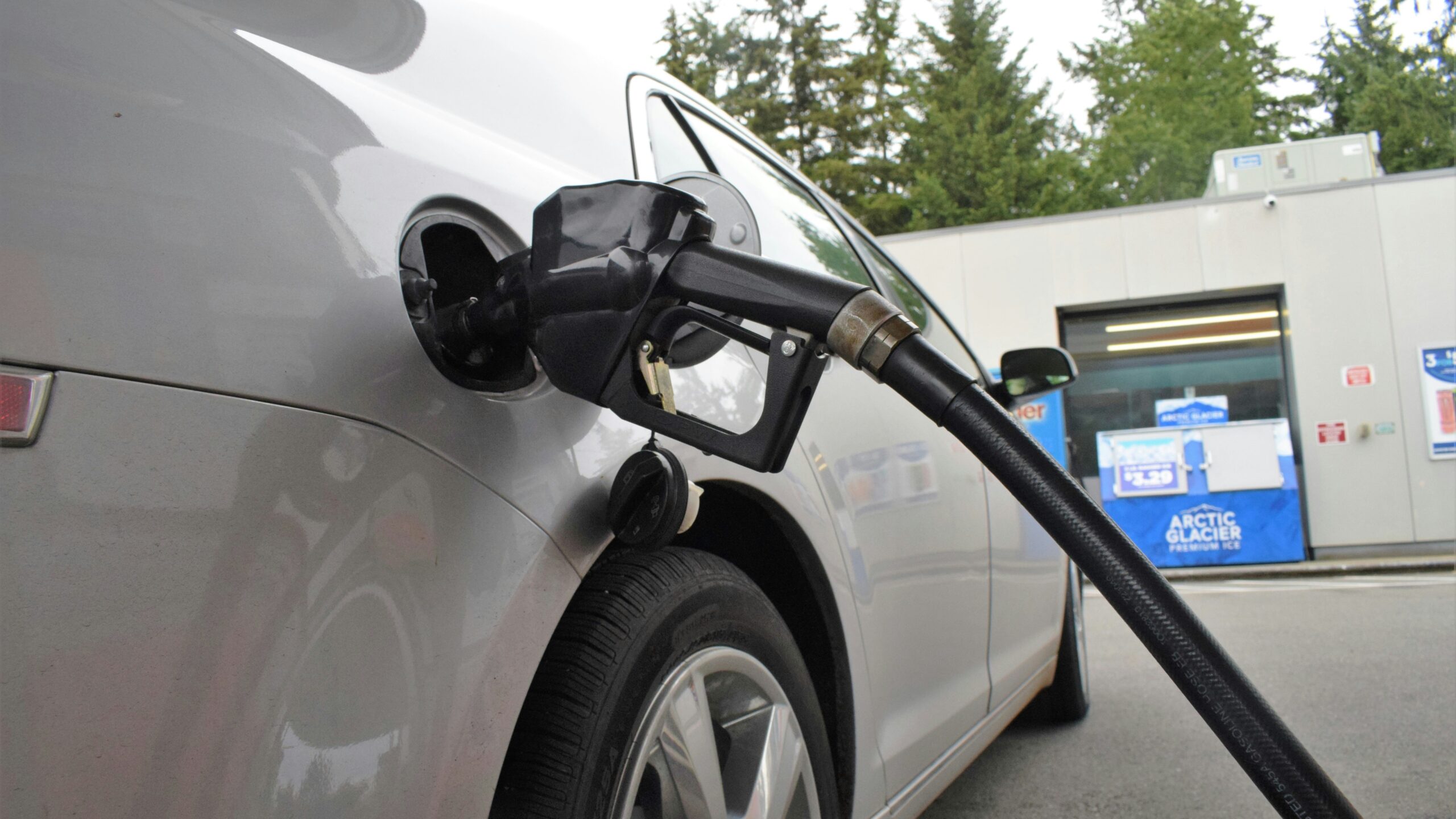 an electric car being charged at a gas station