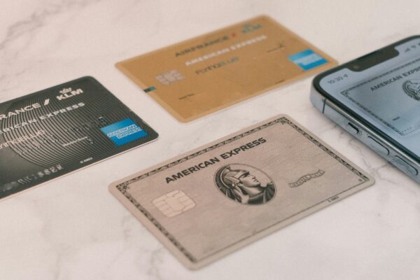a group of credit cards sitting next to a cell phone