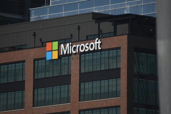 A tall building with a microsoft logo on top of it