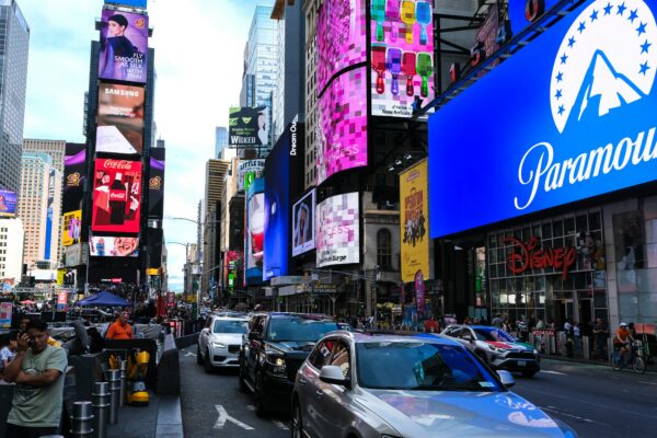 Busy street with cars and bright billboards in times square.