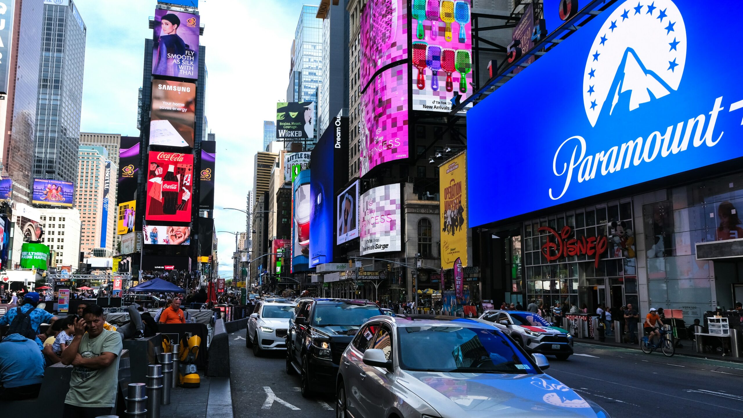 Busy street with cars and bright billboards in times square.