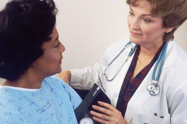 a woman with a stethoscope talking to another woman