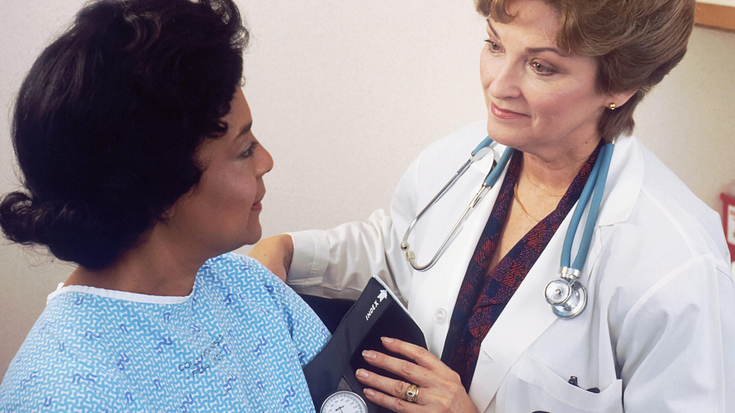 a woman with a stethoscope talking to another woman