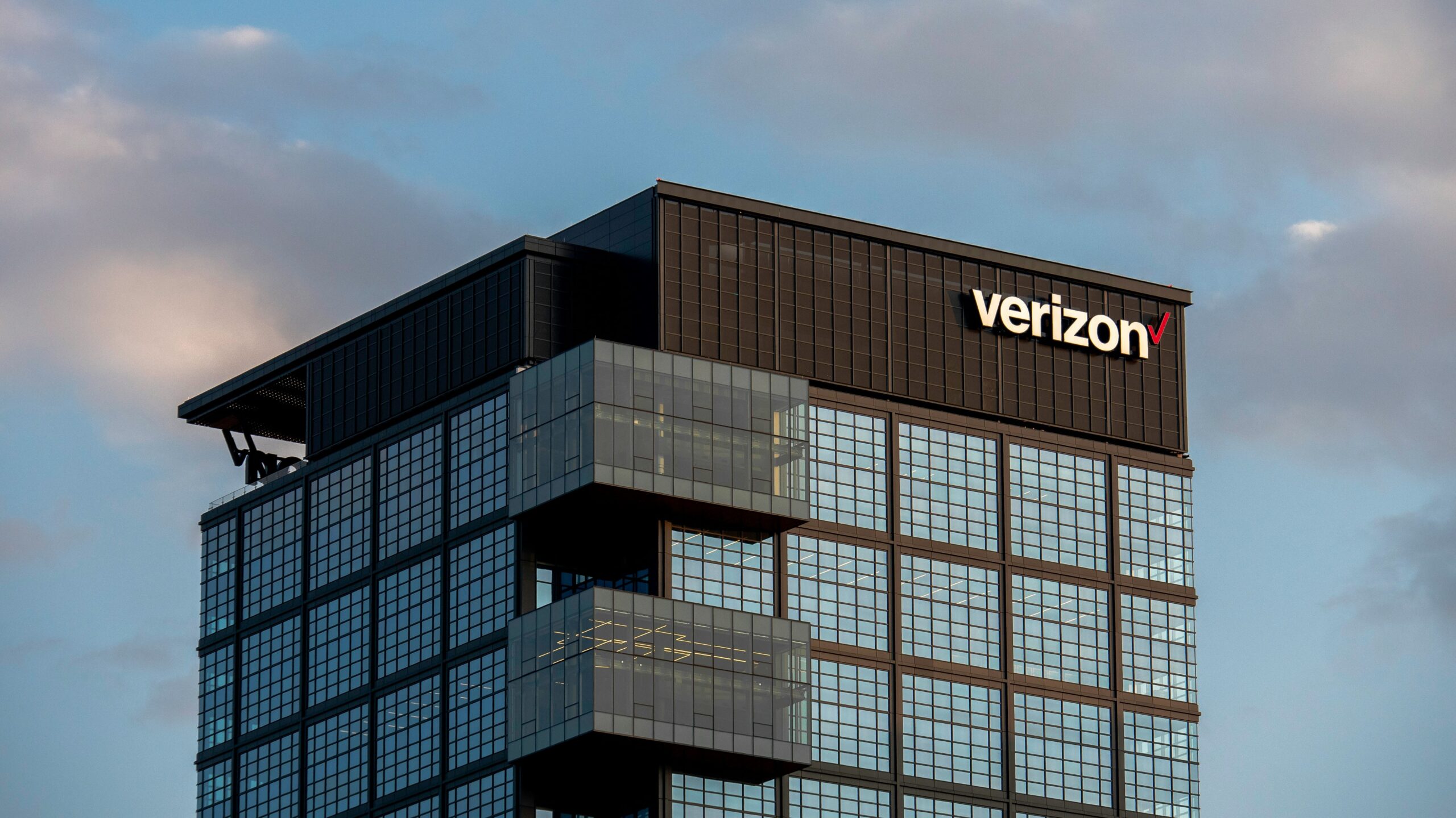 a very tall building with a verizon sign on top