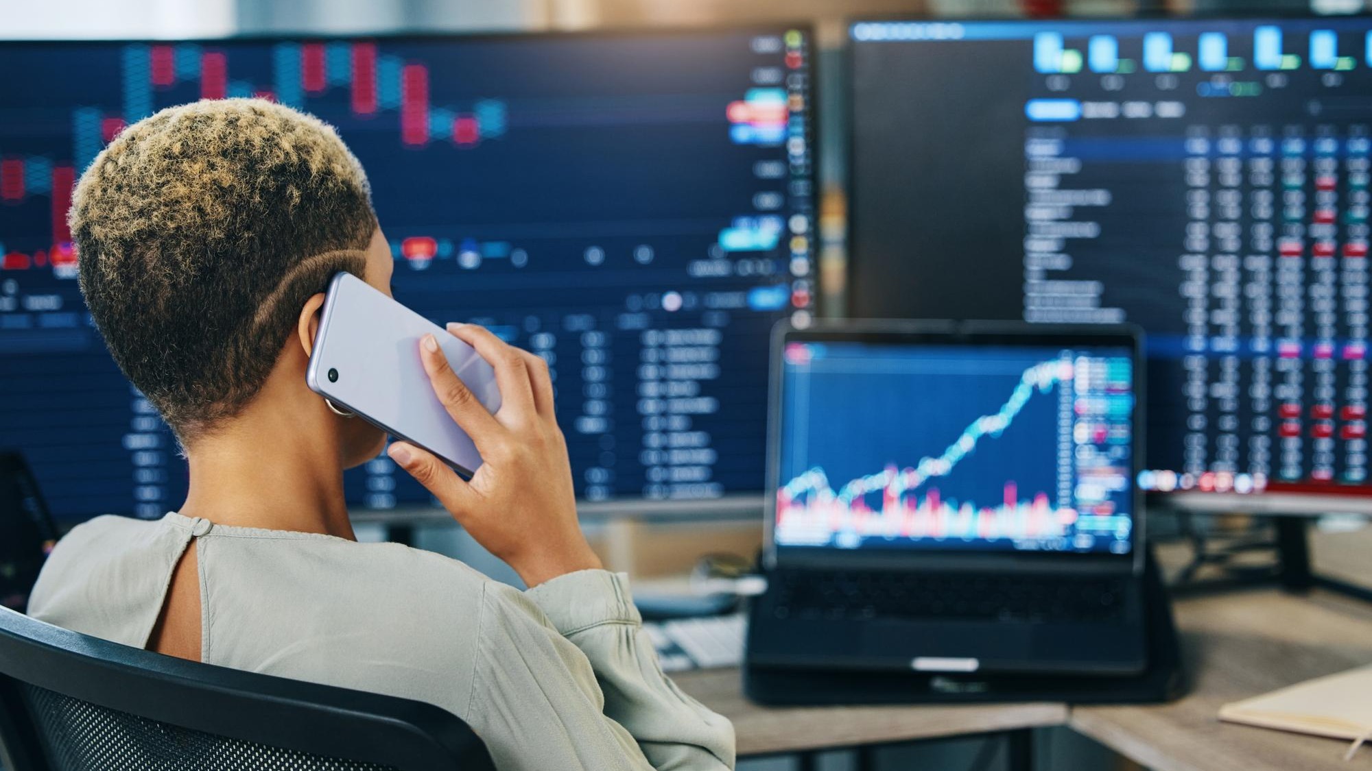 Woman phone call and broker consulting in trading stock market or discussion for online finance at office Business female person or financial advisor talking on mobile smartphone in advice or help