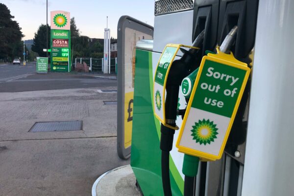 a gas pump with a sign saying sorry out of use