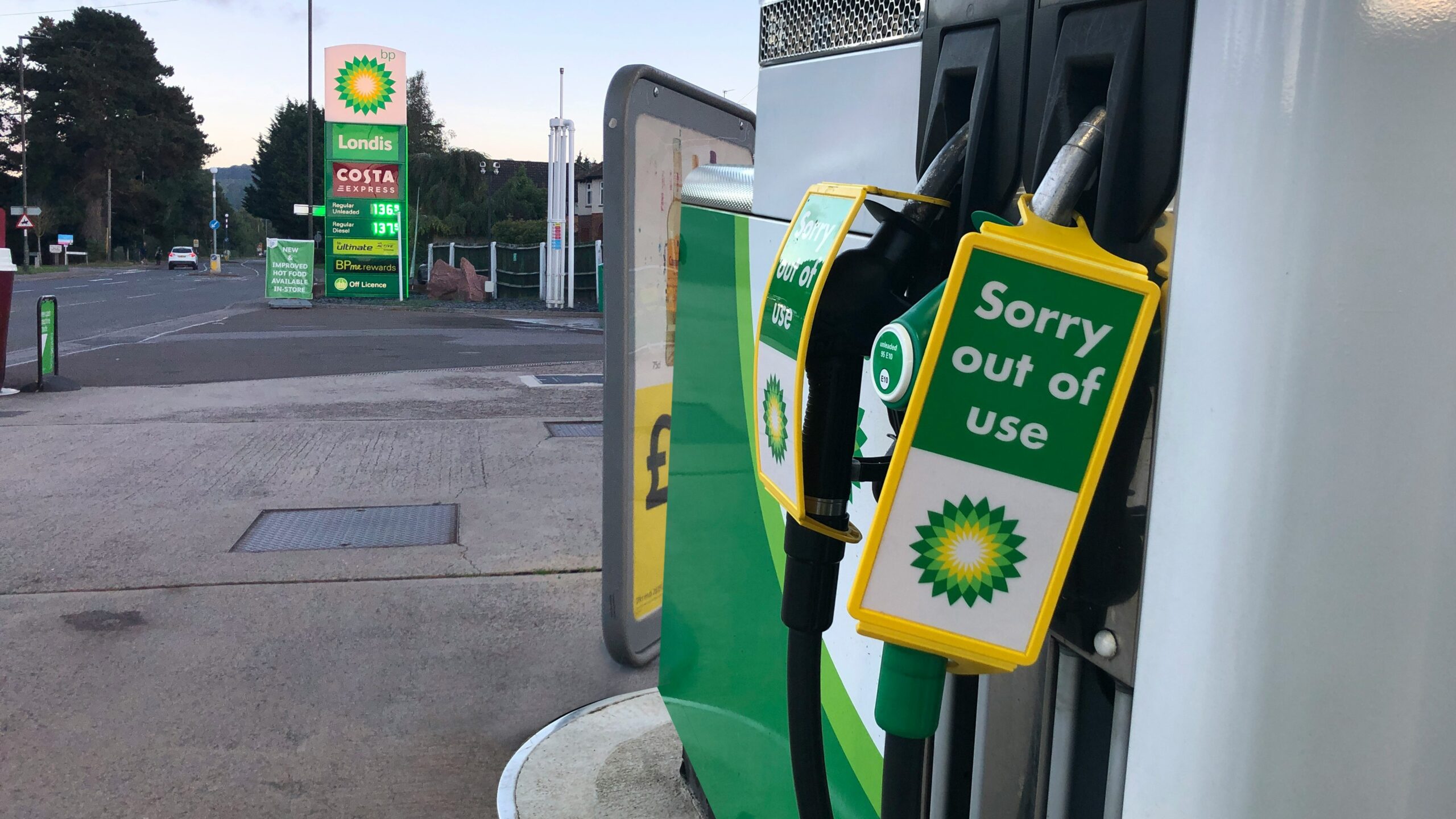 a gas pump with a sign saying sorry out of use