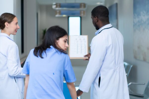 Medical professor and intern looking at an MRI of a patient who received a concussion to the head