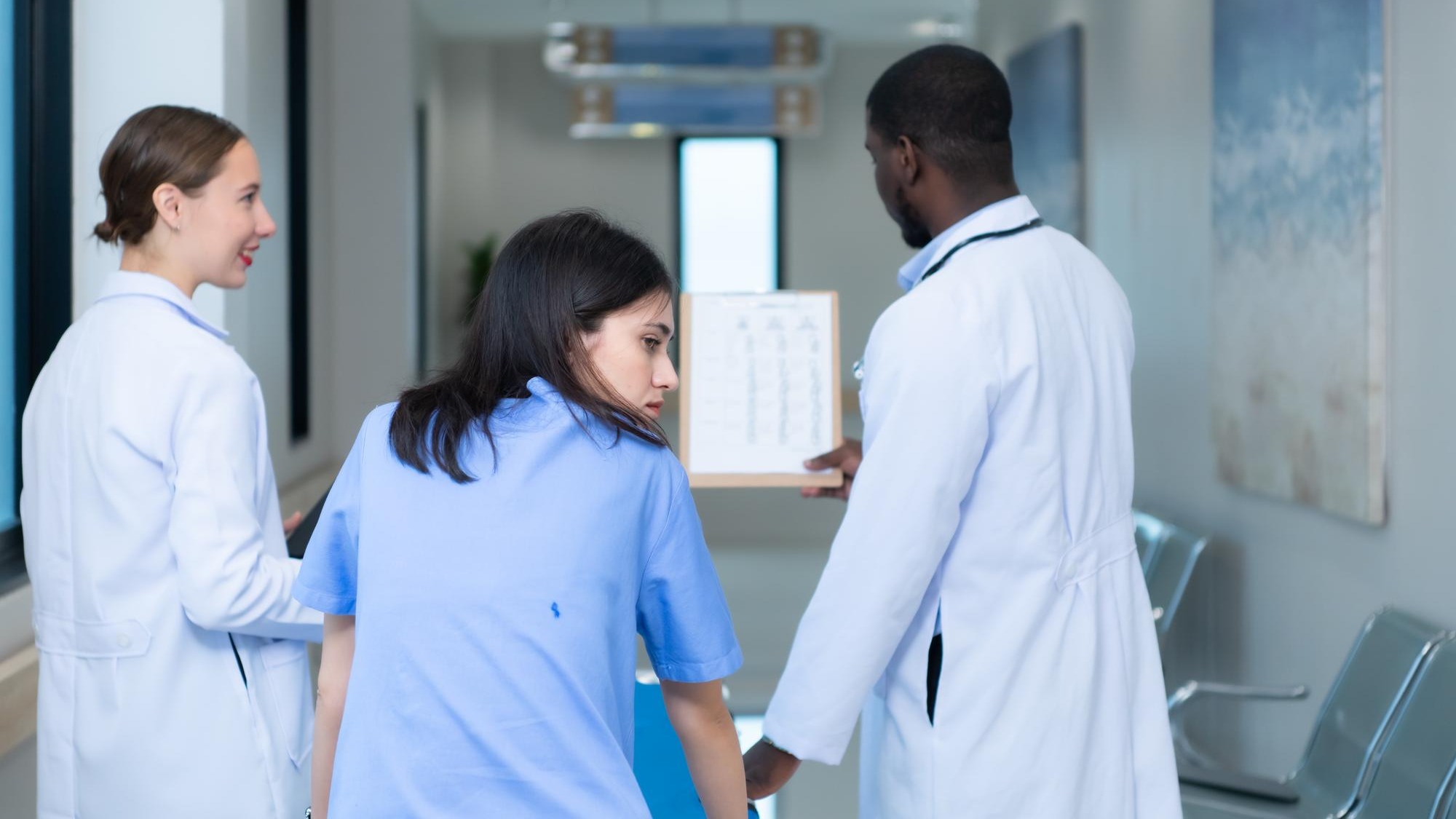 Medical professor and intern looking at an MRI of a patient who received a concussion to the head