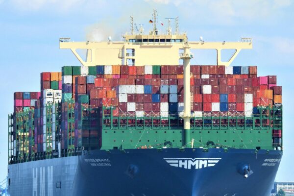 Front view of a massive cargo ship loaded with containers in Hamburg's harbor.