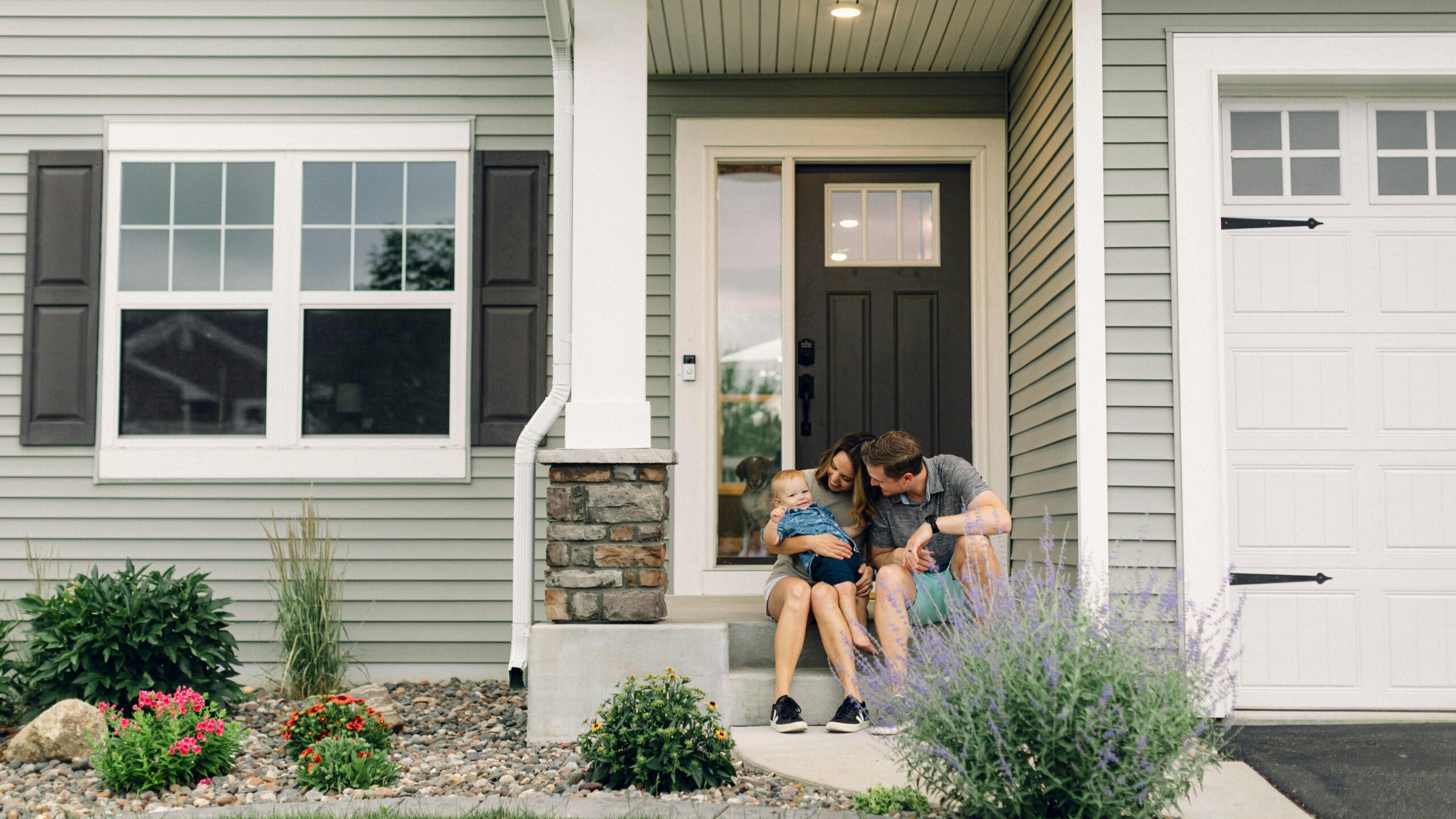 a couple of people that are sitting in front of a house