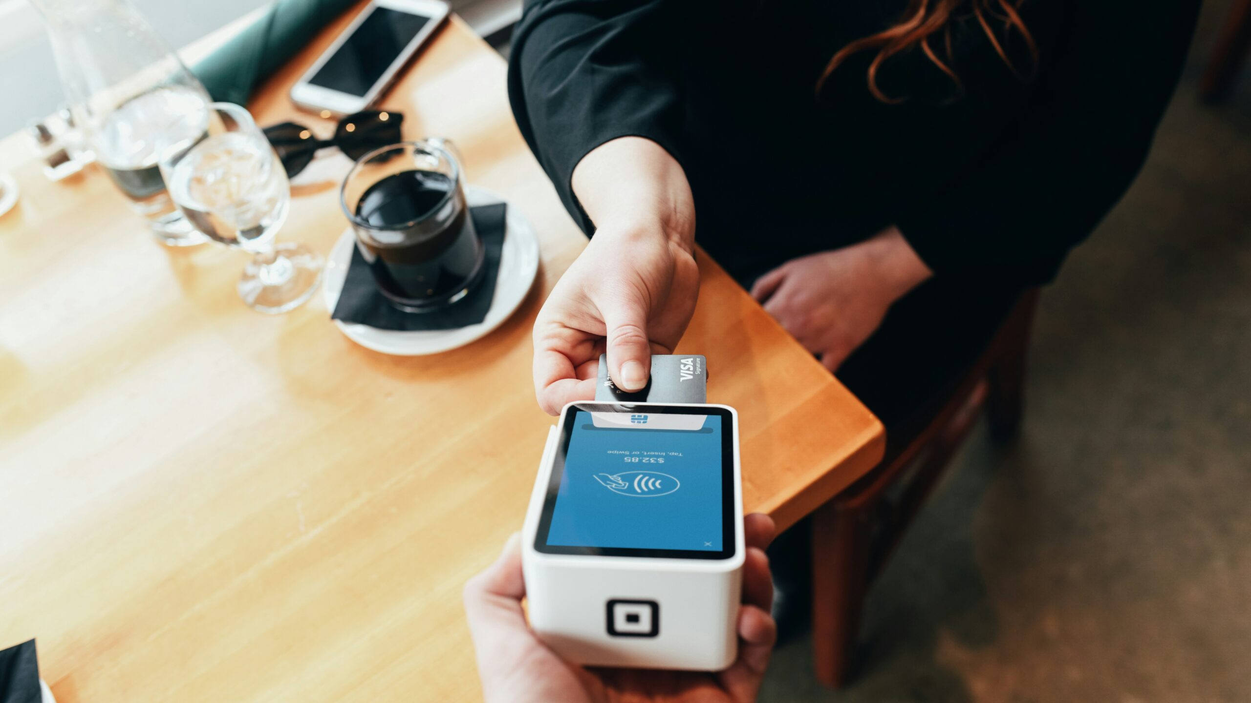 person holding credit card swipe machine