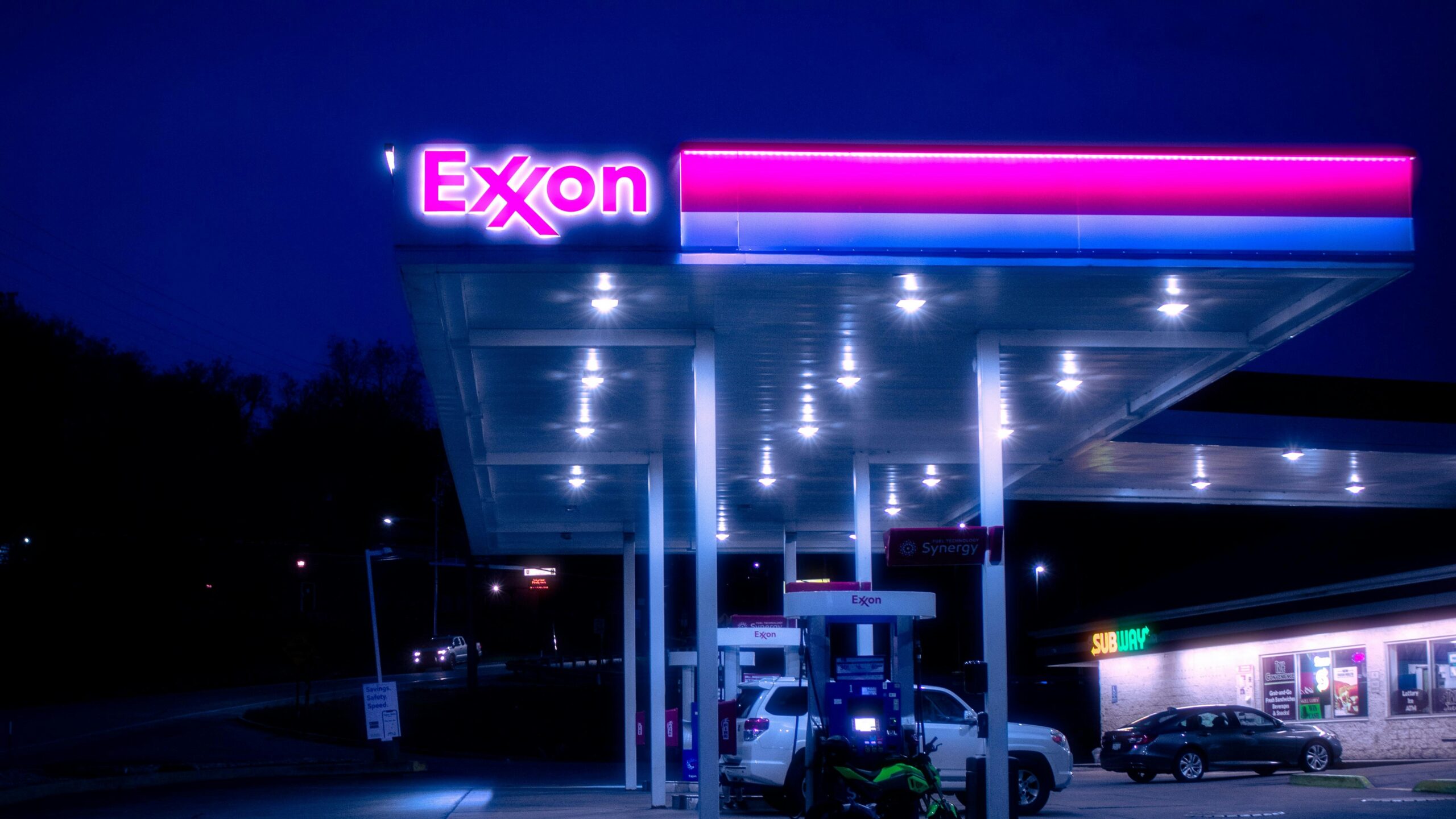 cars parked in front of UNKs store during night time