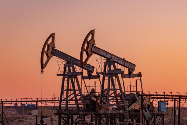 Oil pump rig. Oil and gas production. Oilfield site. Pump Jack are running. Drilling derricks for fossil fuels output and crude oil production. War on oil prices. Global coronavirus COVID 19 crisis.