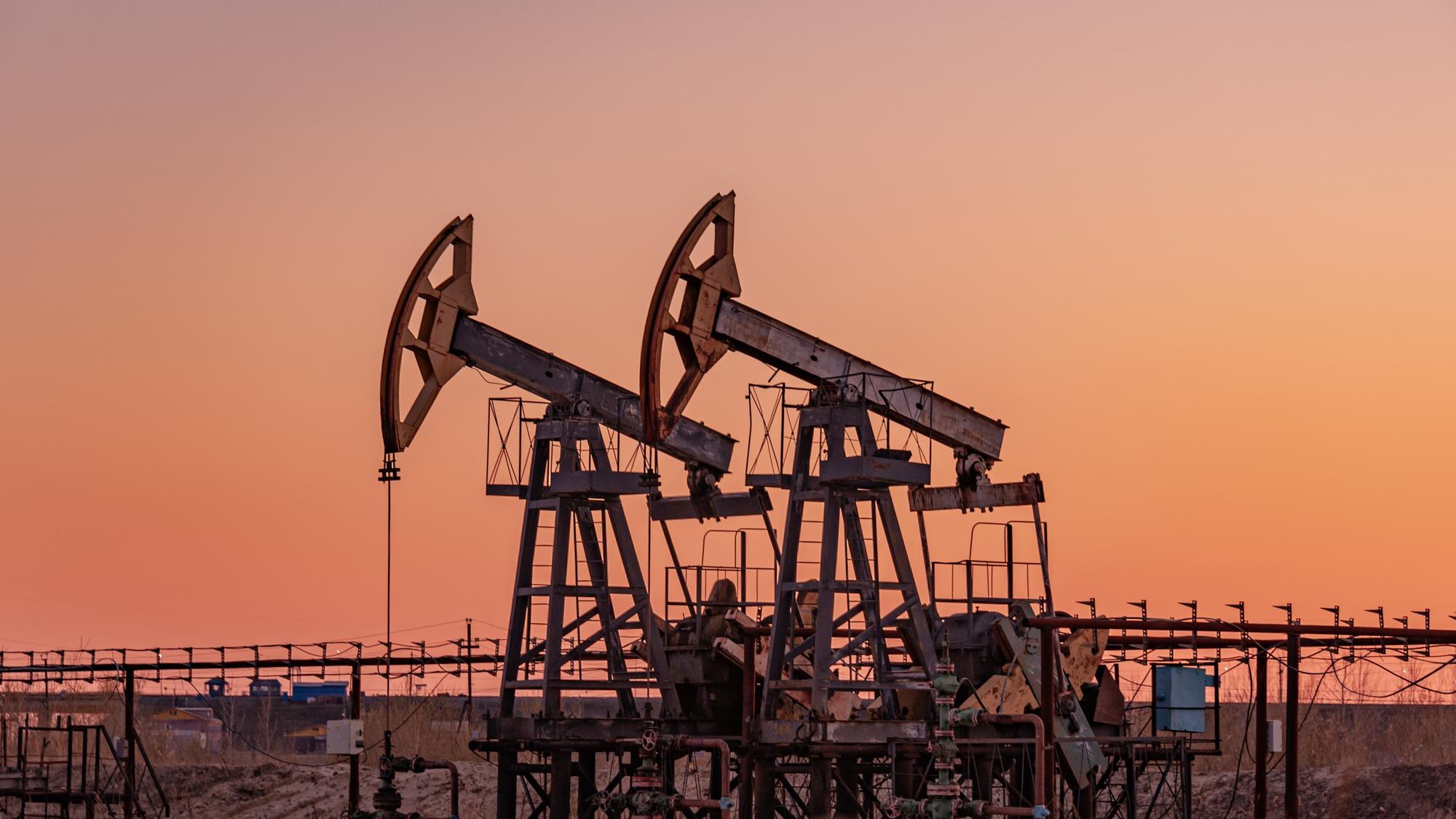 Oil pump rig. Oil and gas production. Oilfield site. Pump Jack are running. Drilling derricks for fossil fuels output and crude oil production. War on oil prices. Global coronavirus COVID 19 crisis.