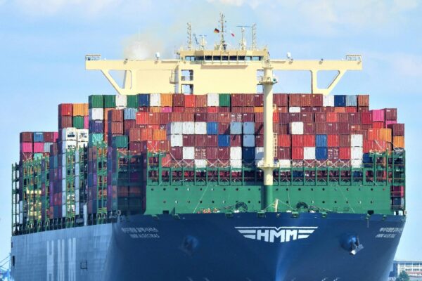 Front view of a massive cargo ship loaded with containers in Hamburg’s harbor.