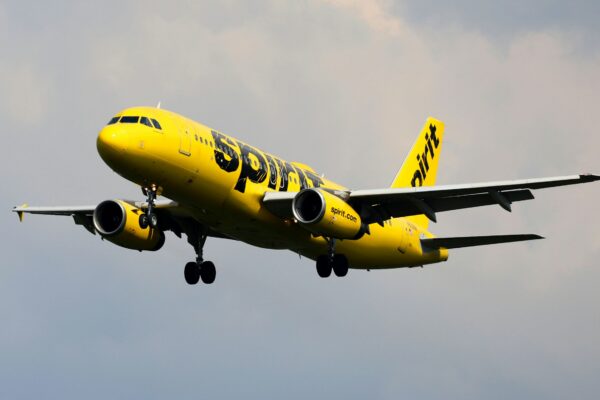 a yellow and black airplane flying