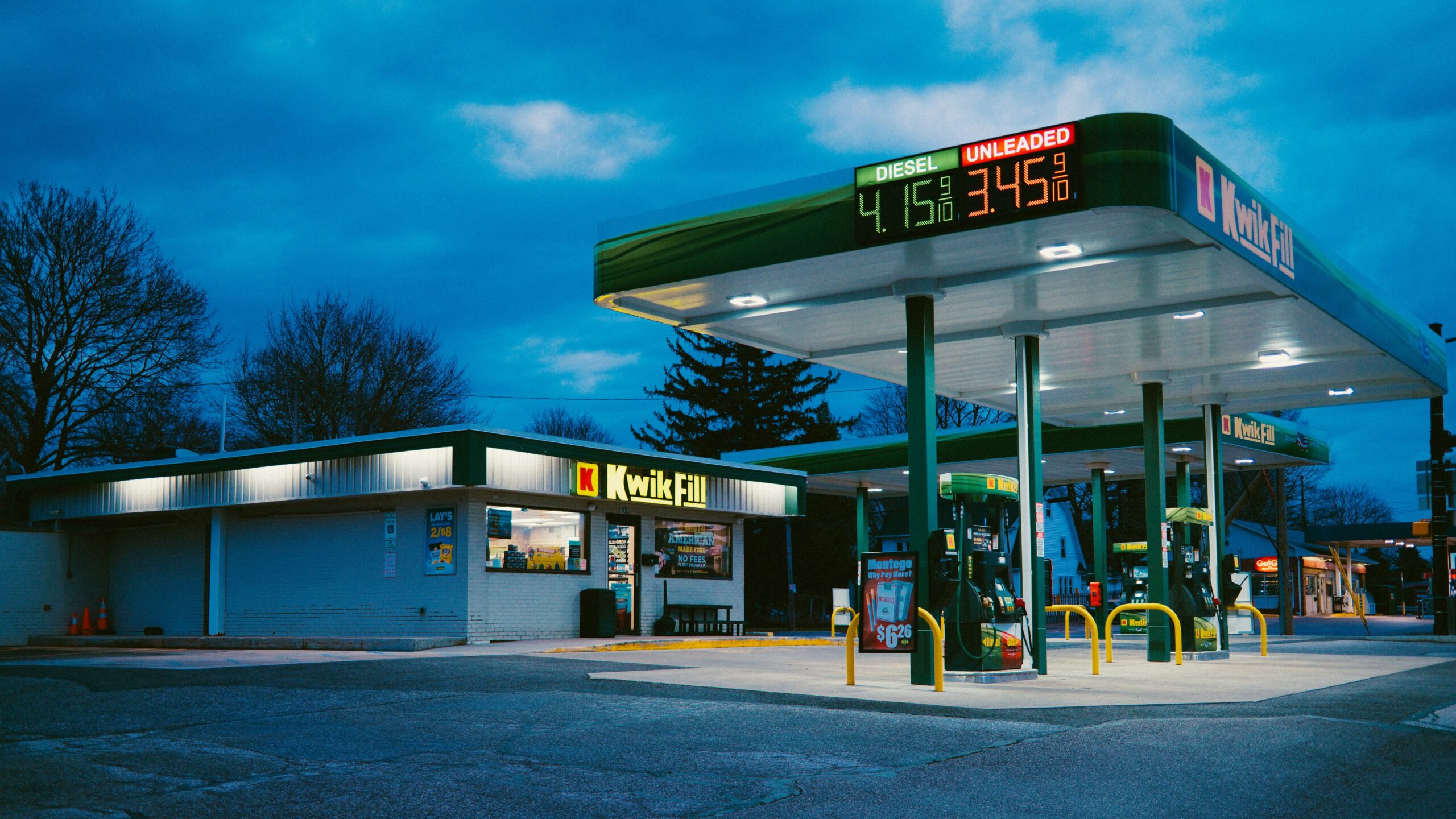 A gas station sits under the night sky.