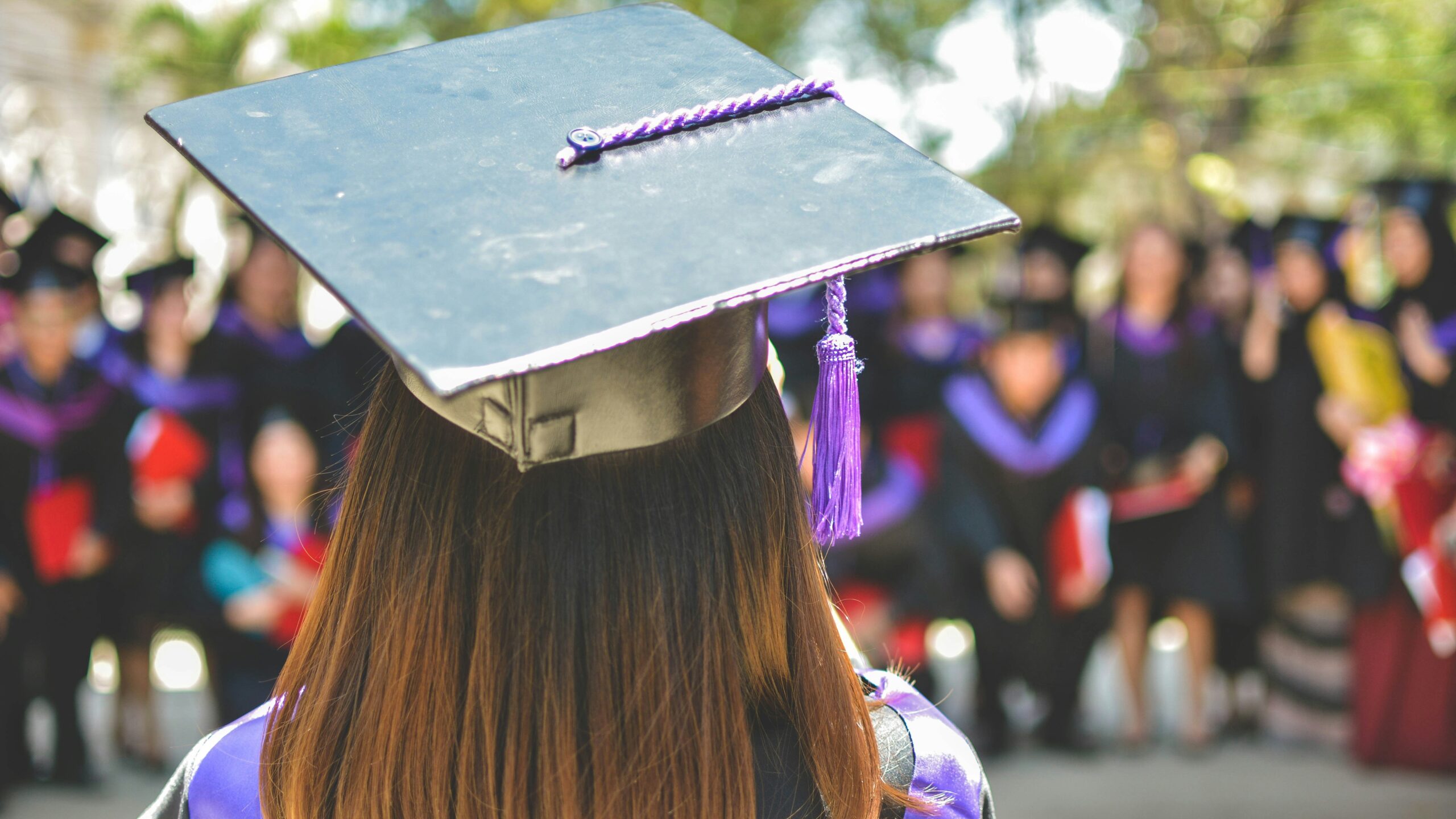 woman wearing academic cap and dress selective focus photography