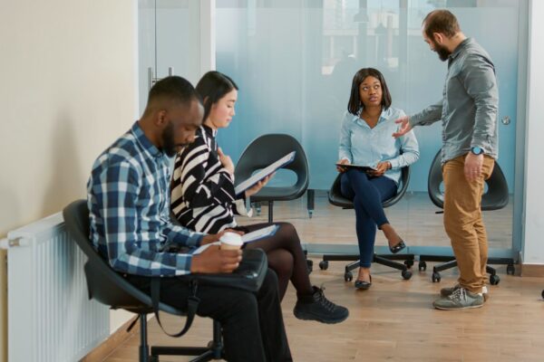 Company employee calling for applicant to attend job interview in office with HR recruiter. Man and job candidate with cv and career opportunity starting hiring meeting, recruitment offer.
