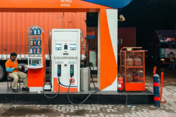 Man sitting at a petrol station at night