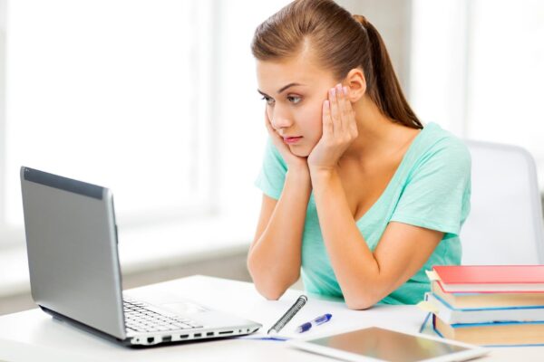 picture of stressed student with computer at home