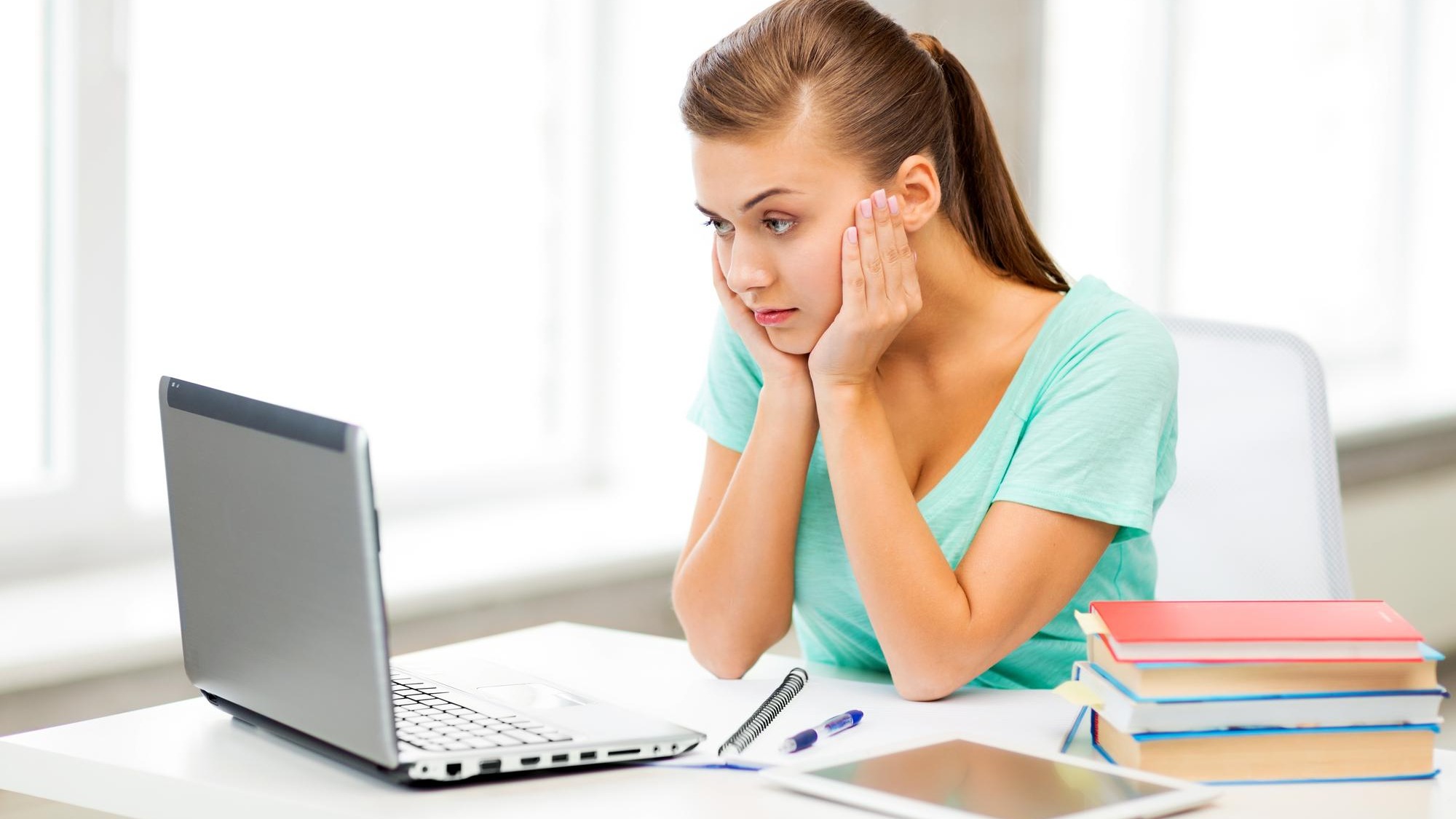 picture of stressed student with computer at home