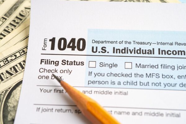 Tax Return form 1040 with USA America flag and dollar banknote US Individual Income