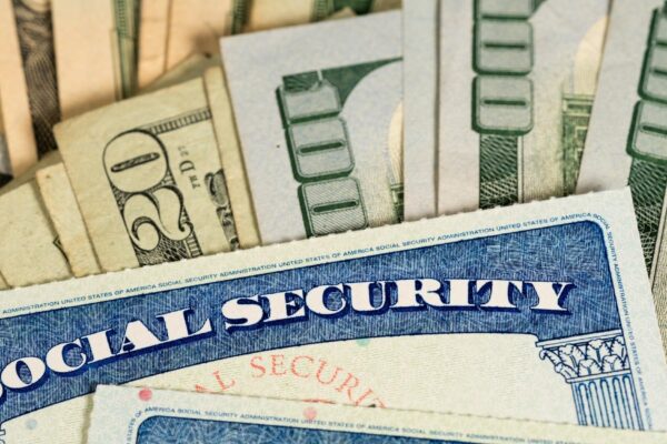 USA Social security cards laid on dollar bills