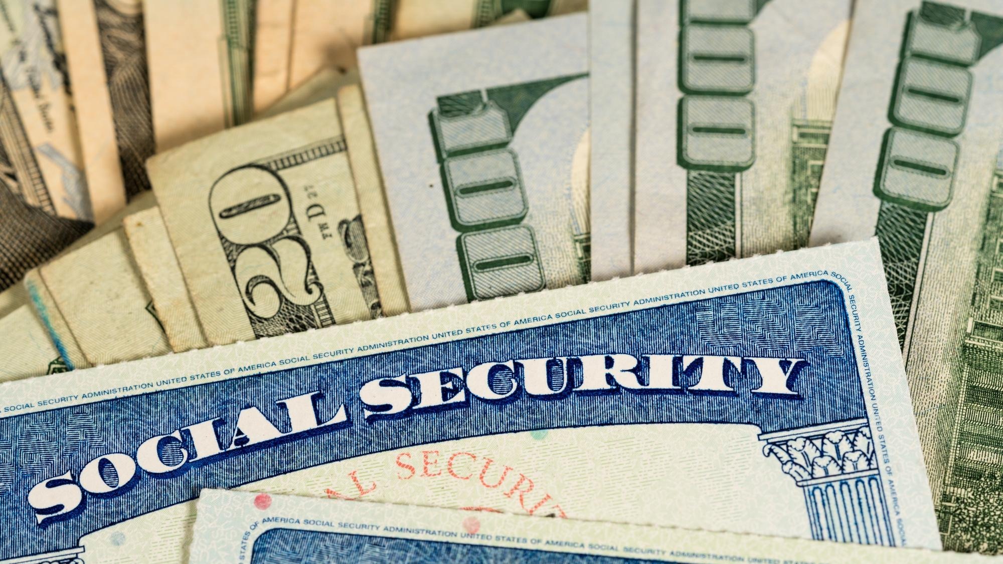 USA Social security cards laid on dollar bills