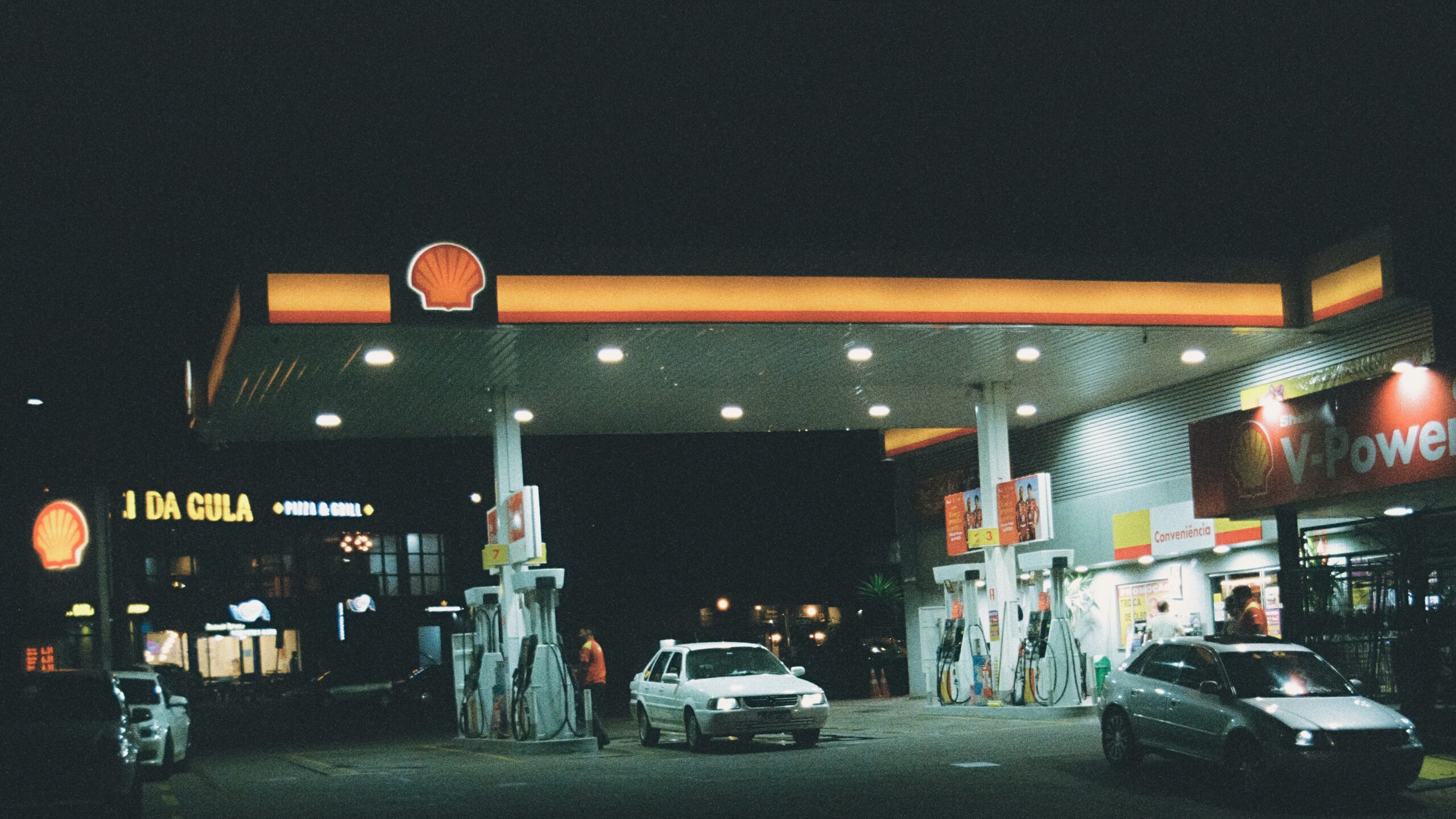 Gas station at night with cars refueling