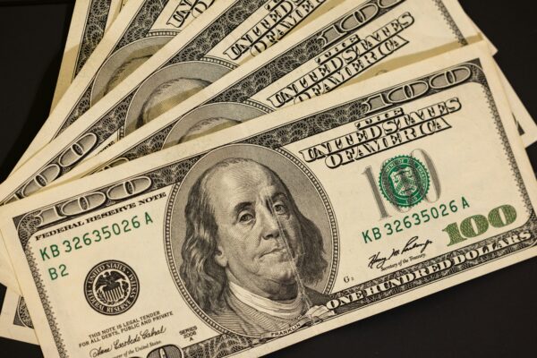 a stack of twenty dollar bills sitting on top of each other