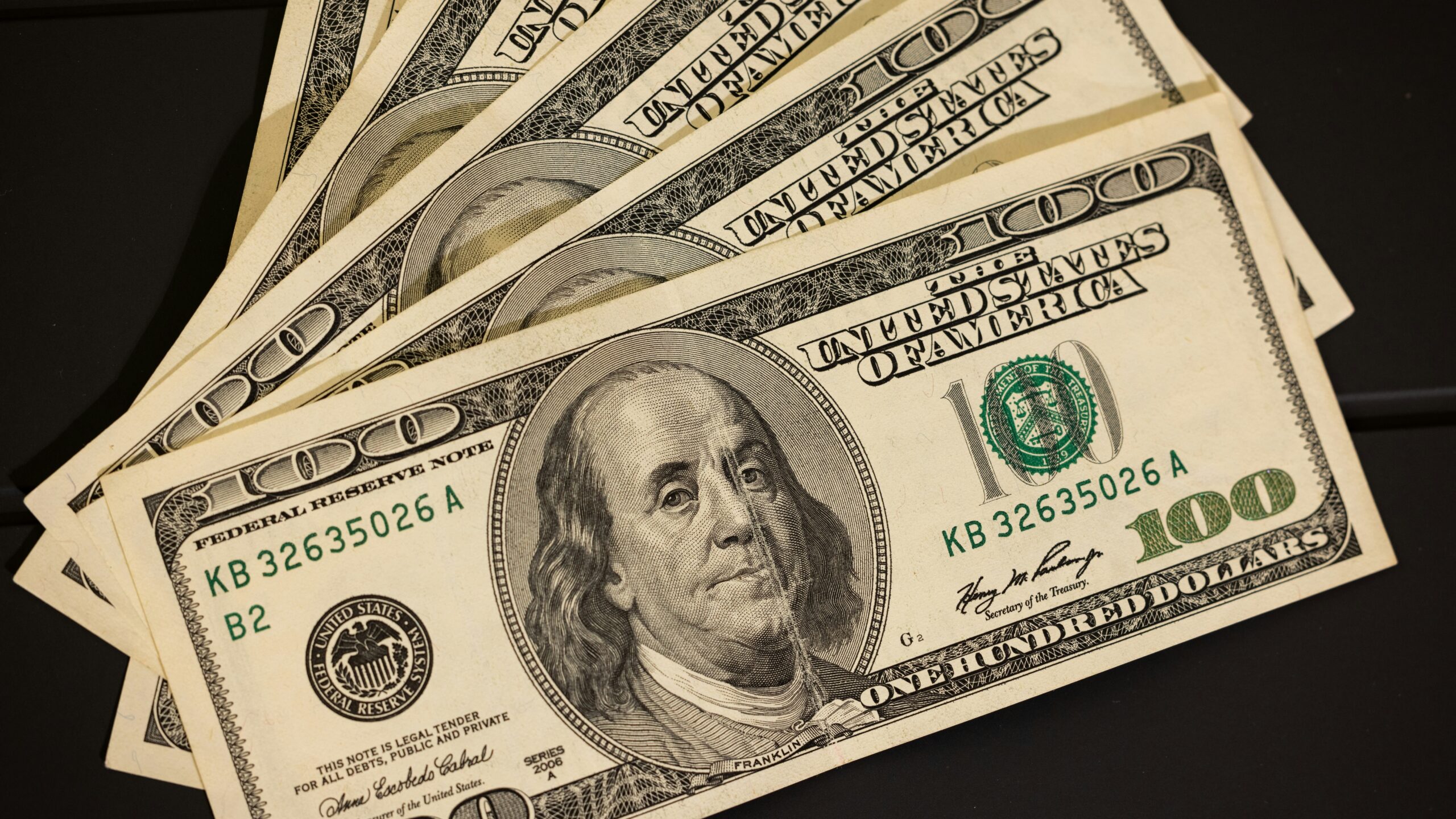 a stack of twenty dollar bills sitting on top of each other