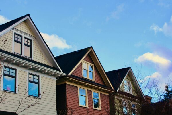 a row of houses with a blue sky in the background
