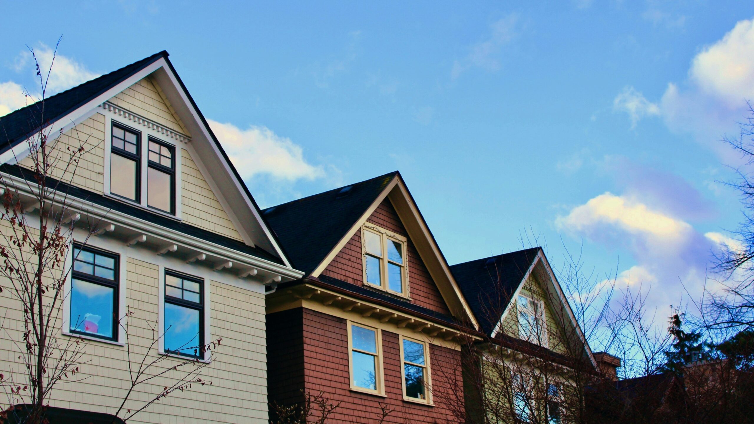 a row of houses with a blue sky in the background