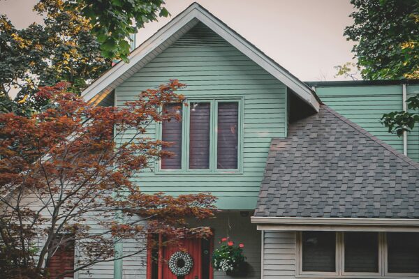 a blue house with a red door and window