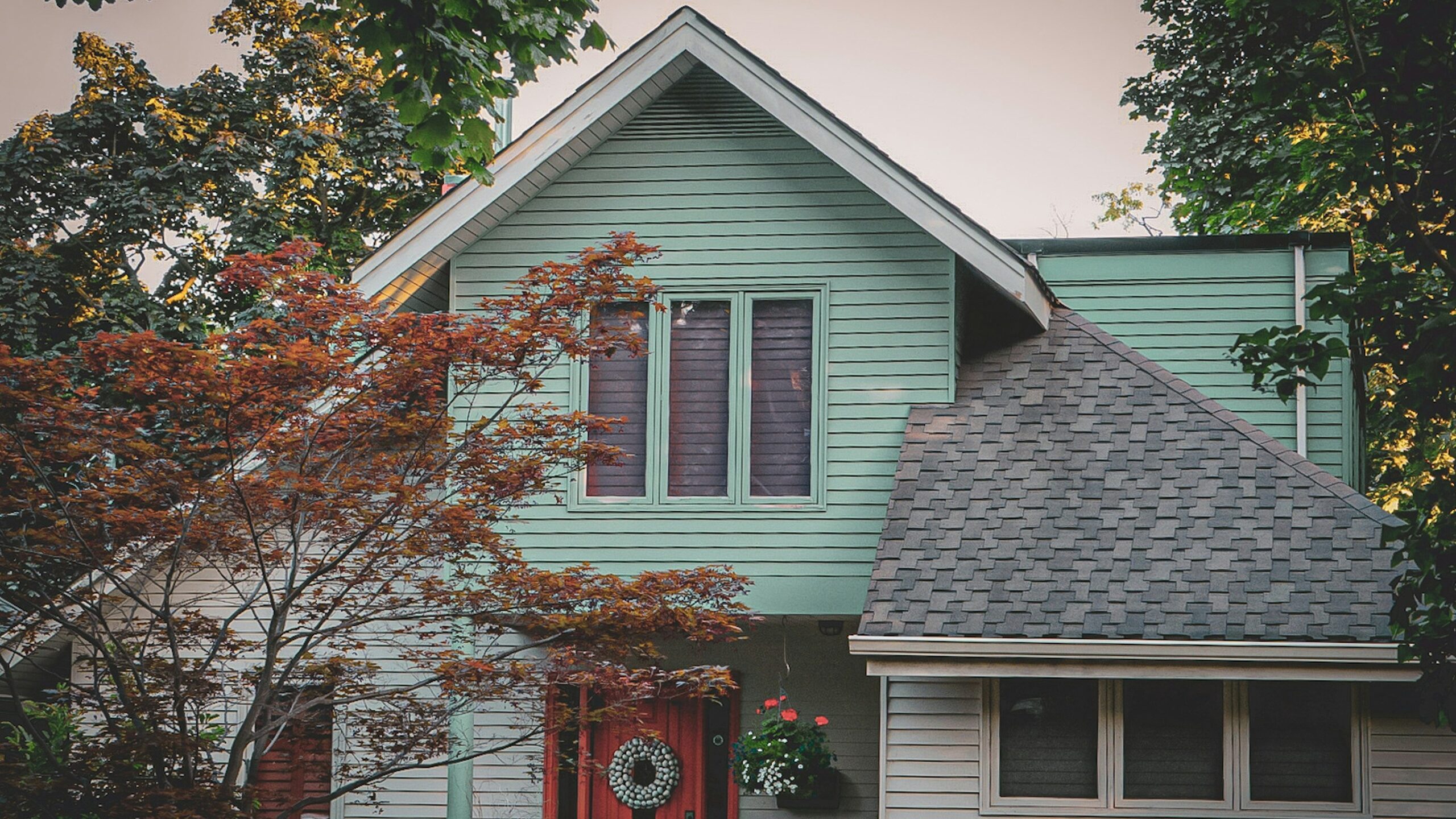a blue house with a red door and window