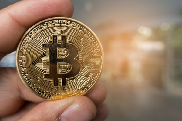 Closeup Golden bitcoin coin in a business office.