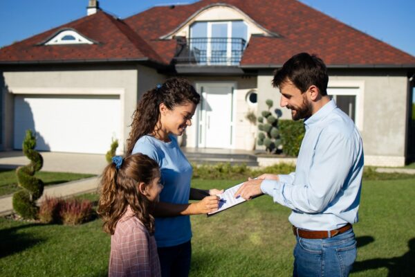 Woman signing the contract and buying new house.